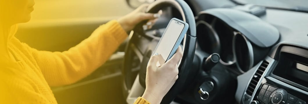 distracted-driving-phone-behind-wheel