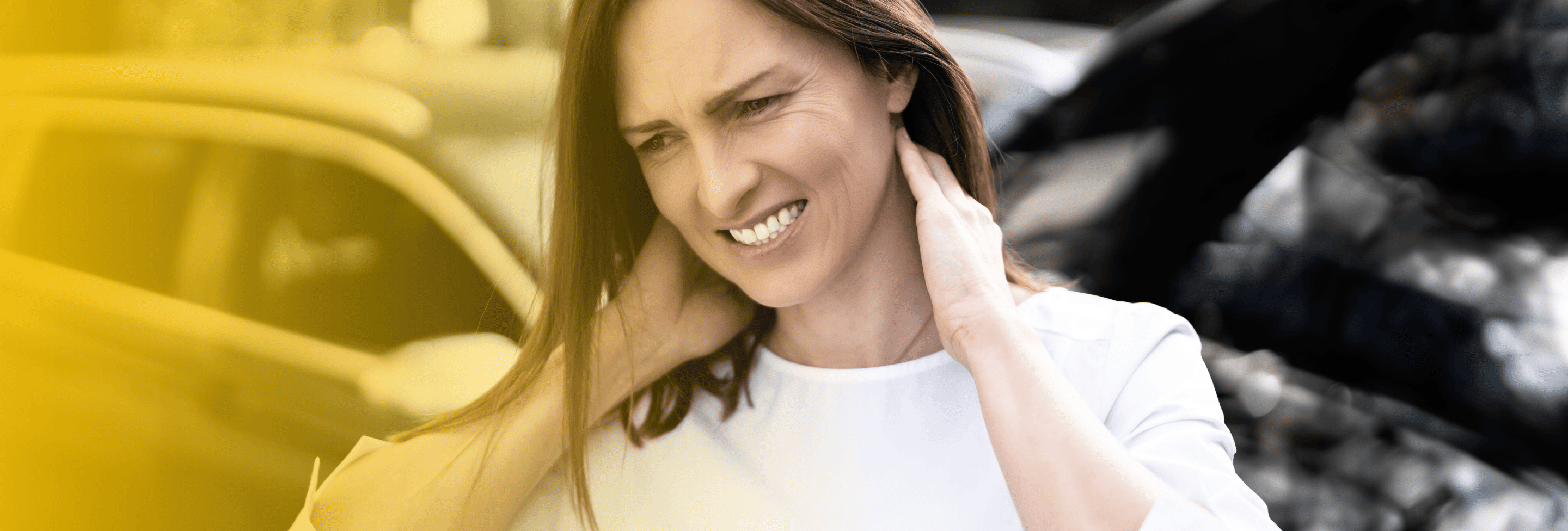 Woman holding neck after car crash with whiplash injury