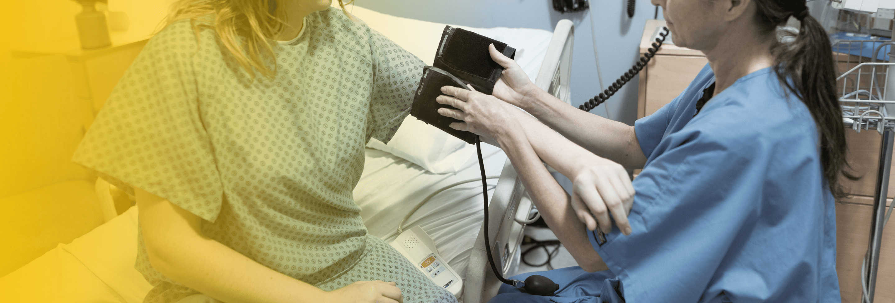 Nurse checking patient’s blood pressure in hospital after car crash