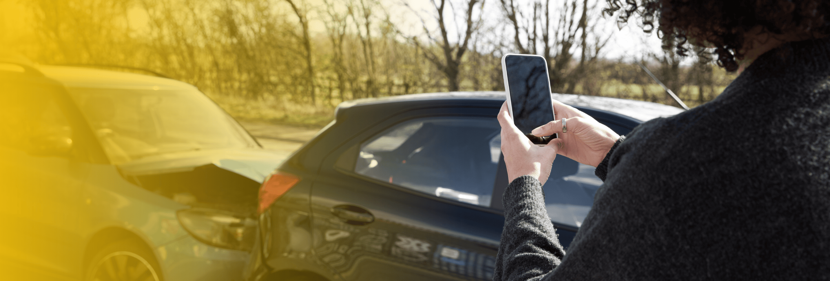 Woman photographing crash damage
