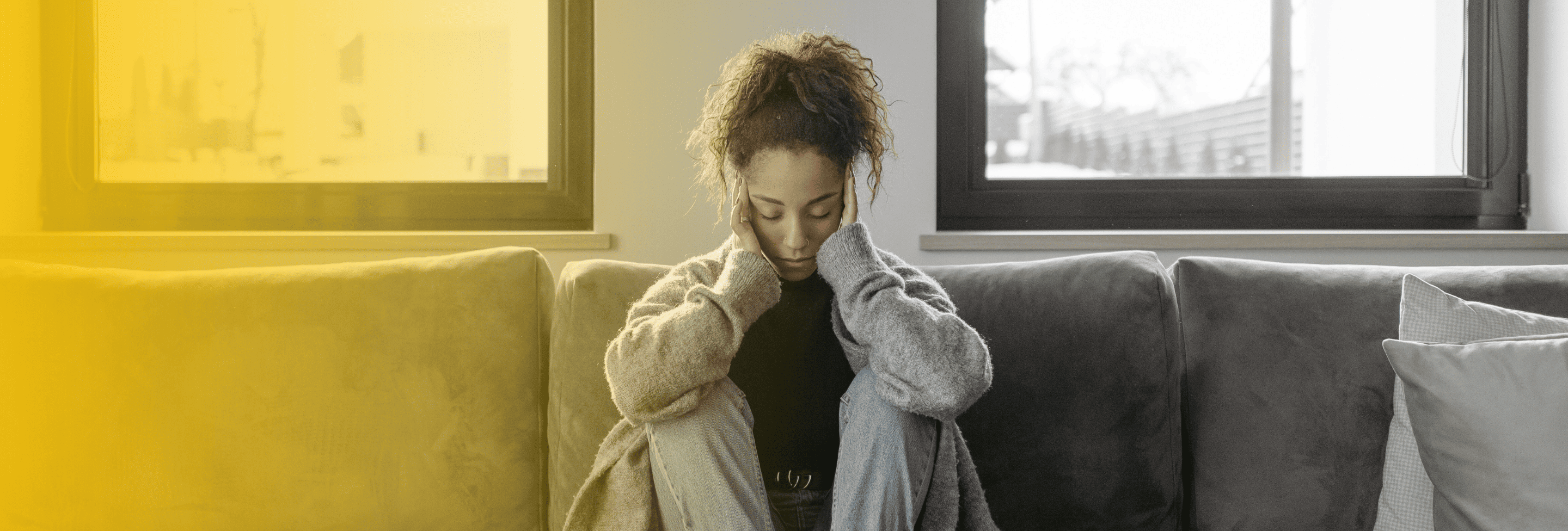 Woman sitting on couch with possible head injury