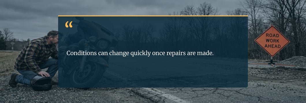 rider-inspecting-damaged-motorcycle-after-hitting-road-defect