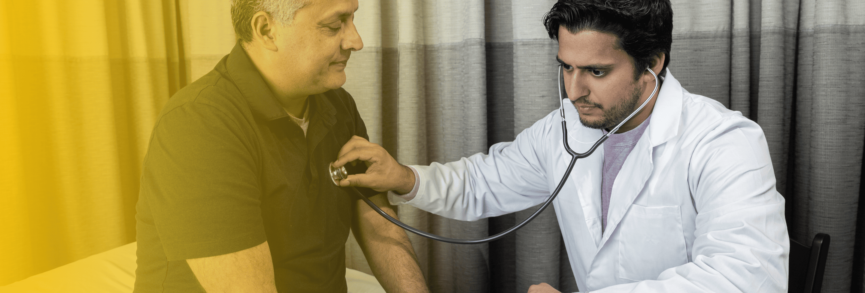 Doctor checking man's heart after car crash