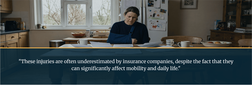 woman-with-shoulder-injury-reviewing-medical-bills-at-kitchen-table