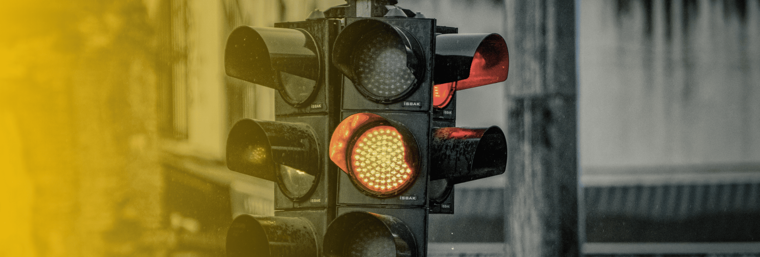 Traffic light showing a yellow signal and importance of slowing down to prevent intersection accidents